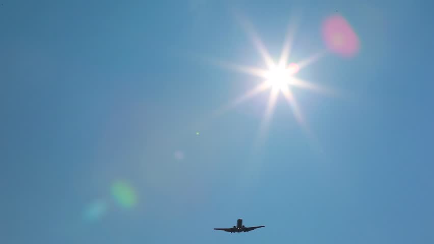 airplane fly over with sun