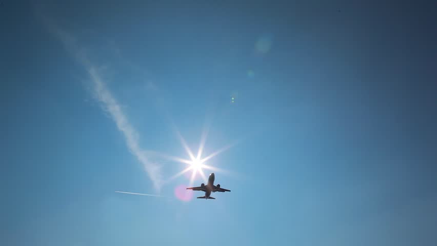 airplane fly over with sun