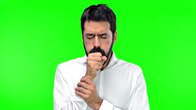 Handsome man coughing a lot on green screen chroma key