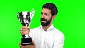 Man holding a trophy on green screen chroma key