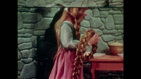 ANIMATED 1950s: Rapunzel and witch puppets sit down at a table together. Man walks along a track with his stick.