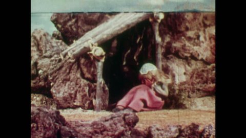 ANIMATED 1950s: Rapunzel sees young man and comforts him. Young man collapses in Rapunzel's arms and she begins to cry. Rapunzel's tears land on blind man's eyes.