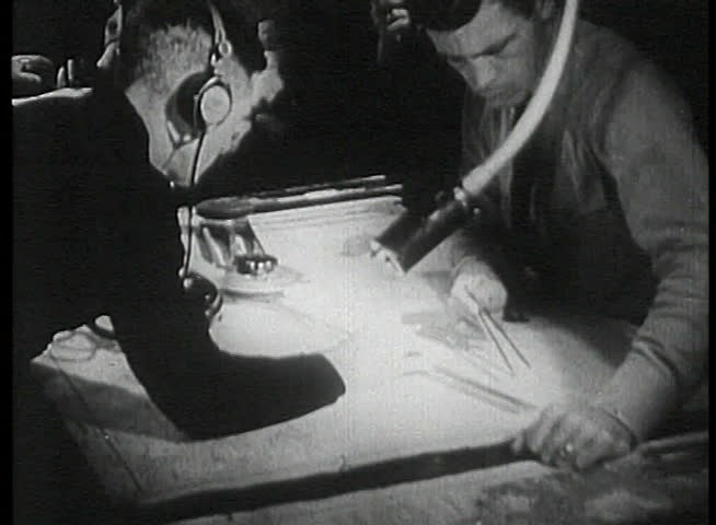 Navy crew taking measurement on map