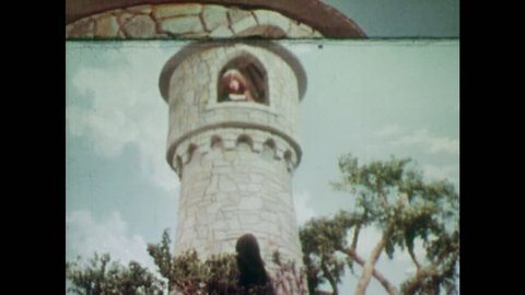 ANIMATED 1950s: Rapunzel sees a witch at the bottom of the tower she lives in. Rapunzel lets her hair down so the witch can climb up to the tower. Witch touches Rapunzel's hair and gets a shock.