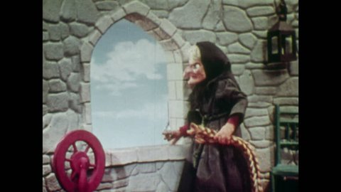 ANIMATED 1950s: Witch puts scissors in her pocket; lowers Rapunzel's hair down to young man. Man starts to climb. Man is surprised when he reaches her window. Witch puts spray in man's eyes.