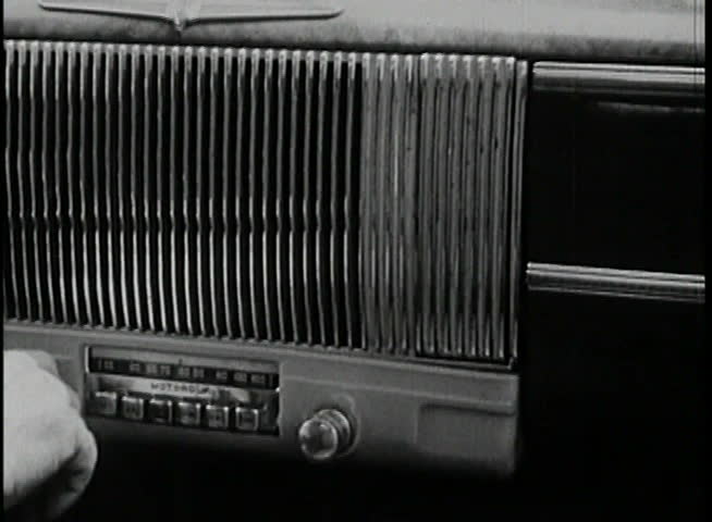 Close-up of hand tuning radio in vintage car