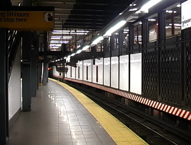 A New York City subway pulling into the platform.