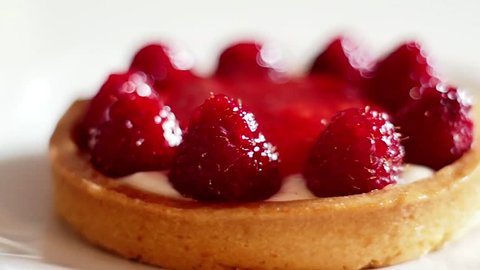 Tasty Raspberry Tart on a White Plate, Wonderful Sweet Dessert, Extreme Close Up, Panorama. Beatiful desert for classic afternoon tea. Calories count, organic, diet.