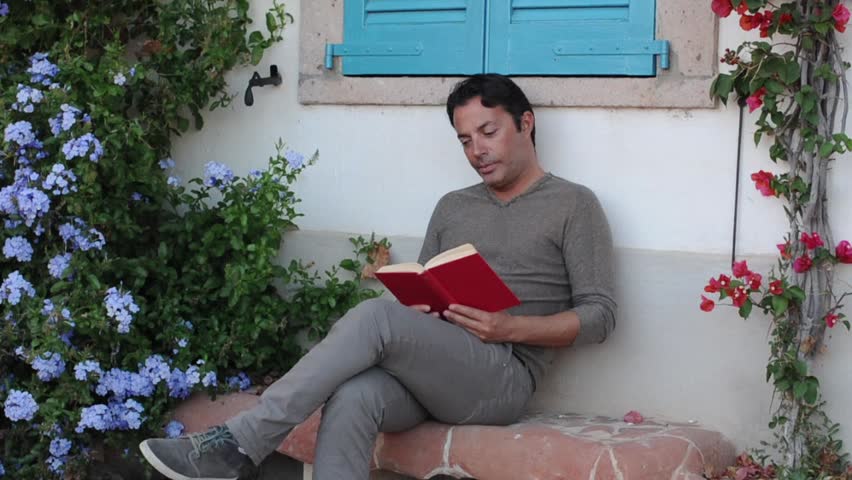 Man reading book outside, selective focus