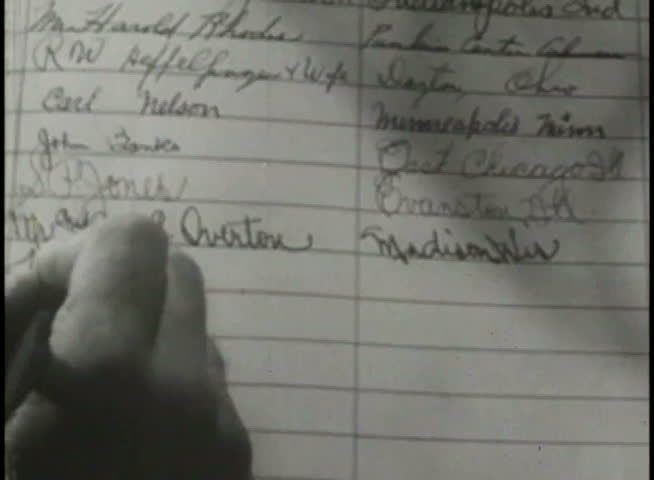 Close-up of person signing name in register