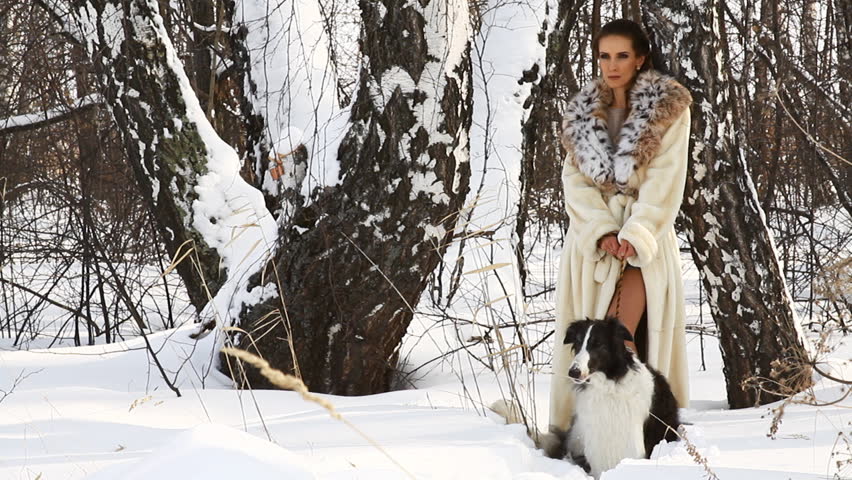 beauty woman with dog in winter country