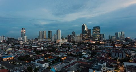 Time lapse of sunset over Jakarta skyline, Indonesia capital city as a day to night video over the Kuningan business district. Jakarta is South East Asia largest city. 