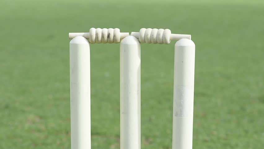Bails fly off cricket stumps after being hit by a cricket ball Royalty-Free Stock Footage #21083371