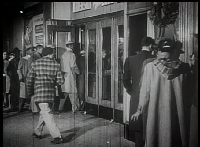 Line of people entering theater