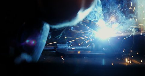 Close-up of welder welding a metal in workshop