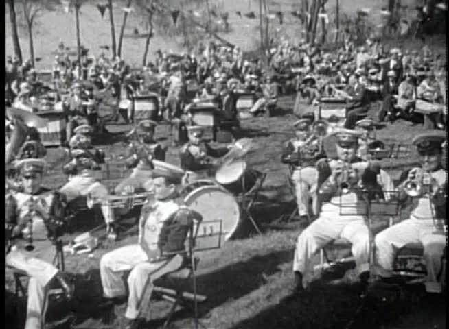 Wide shot of band playing for outdoors audience