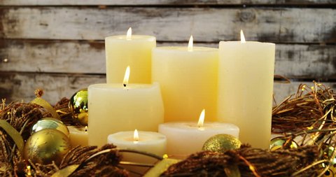 Burning candles with christmas decoration on wooden plank during christmas time 4k