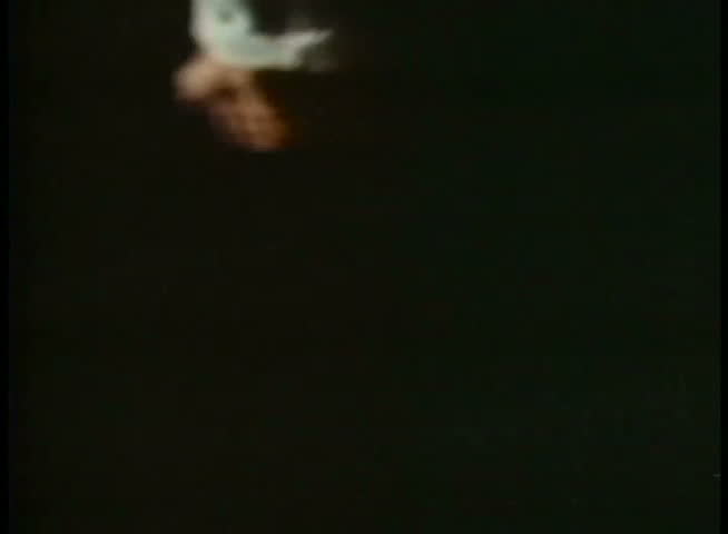 Man jumping in water at night