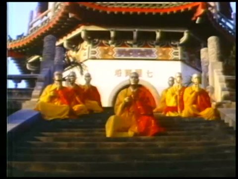Monks praying on steps in front of shaolin temple