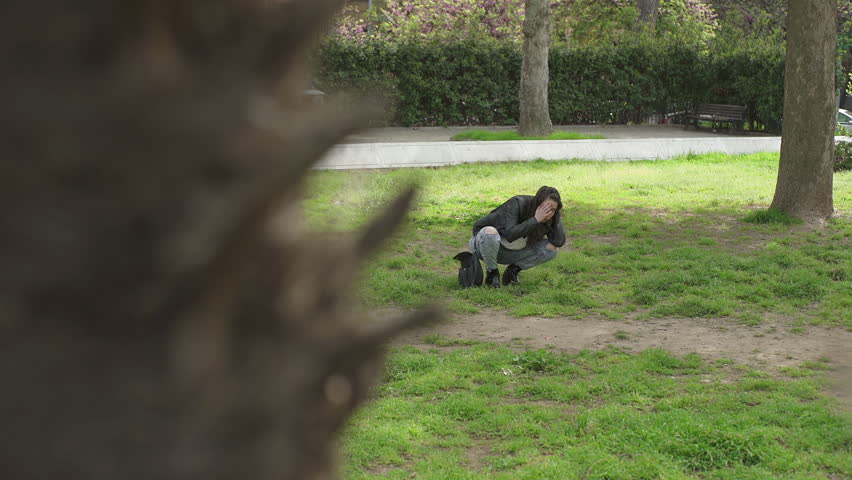 lonely young woman in a park while having a illness