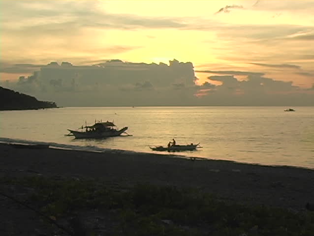 Sunset with Philippine fishing boats silhouetted 