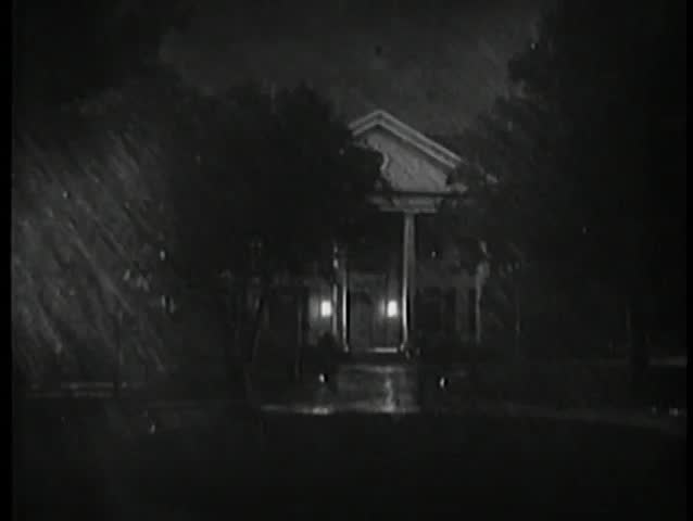 Establishing shot of mansion during thunderstorm