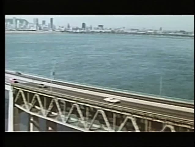 Aerial view of cars driving across bridge
