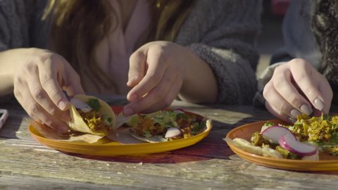 Closeup Of Woman Taking First Bite Of Her Taco, She Savors It 