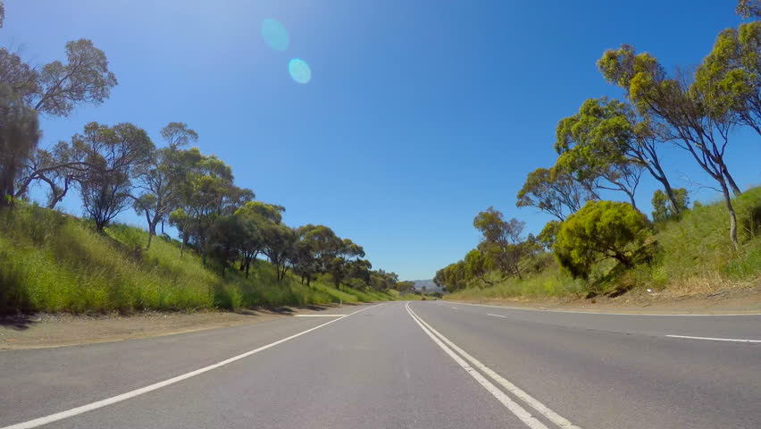 Australian country road vehicle POV, driving along highway freeway with views of McLaren Vale, South Australia, in the distance. 