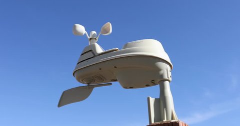 FOUNTAIN GREEN, UTAH - NOV 2016: Weather station wind gauge blue sky. Private home based weather station to measure seasonal weather, temperature, humidity and winds. Forecast future weather. 