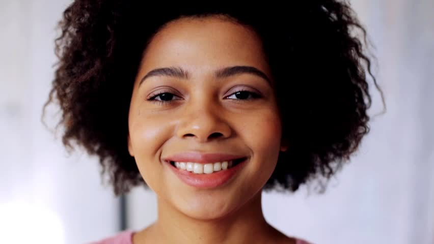 Race, ethnicity, people, emotion and facial expression concept - happy smiling african american young woman face | Shutterstock HD Video #21124285