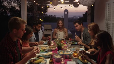 Friends make a toast over dinner on a roof terrace, Ibiza, shot on R3D