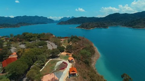 Aerial: Drone flies high above the lake. Panorama.