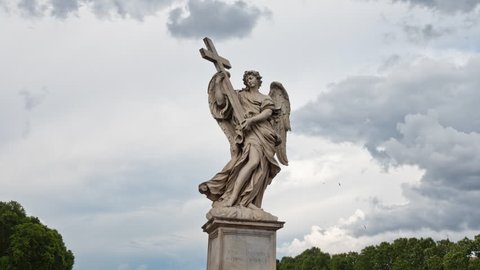 Time lapse with clouds behind the Angel with the Cross closeup on the Bridge of Hadrian (Ponte Santâ??Angelo) in Rome, Italy.