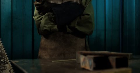 Portrait of Caucasian female welder standing with arm crossed in workshop 4k