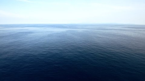 peaceful and calm shot of a gently lapping sea and nice sky with cloud, view from forward point of open deck of a cruise ship.