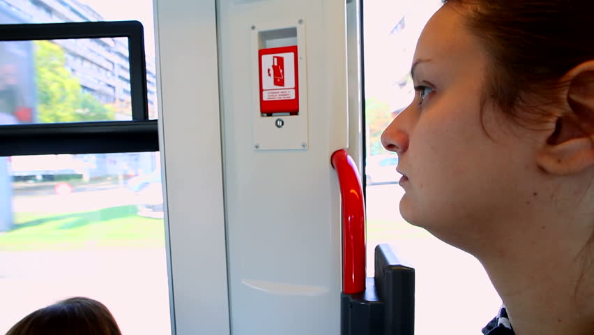 Young woman riding the tram in the city