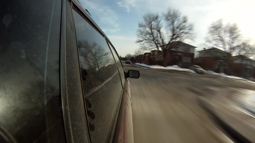 High Definition time lapse of a car driving on streets during winter.