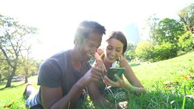 Couple at Central park listening to music on smartphone