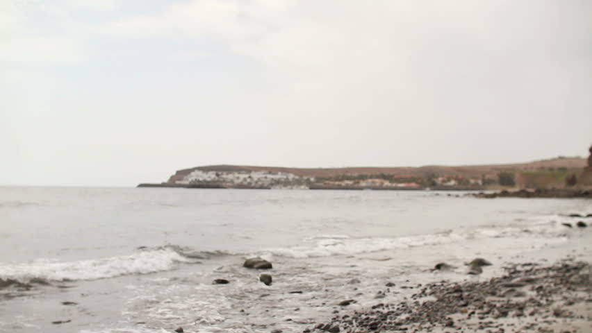 Young happy man standing on the beach
