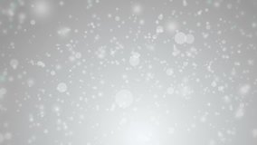 Soft beautiful grey backgrounds.Moving gloss particles on silver background loop. Winter theme Christmas background with snowflakes.