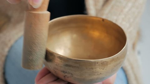 Close up shot of nepal singing bowl in woman's hand. Meditation and relax concept