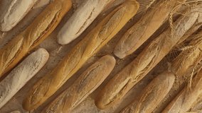 Beautiful composition of bread, flour and wheat. Flour falling on bread in slow motion.  Shot on RED EPIC DRAGON Cinema Camera.