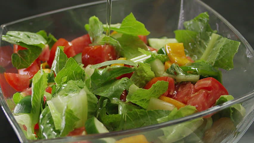 Salad preparation process. Olive oil poures into the salad. Shot on RED EPIC DRAGON Cinema Camera.