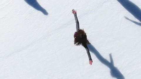 Aerial view of ice skating woman outdoor, ice rink Medeo