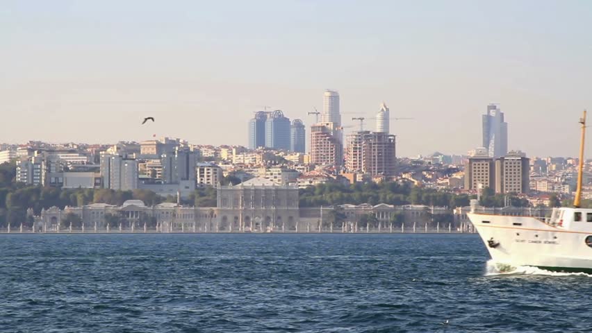 Ferry sails in front of Dolmabahce, Istanbul, Turkey
