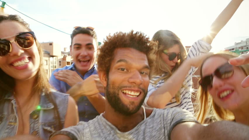 Close up of happy crazy multi-ethnic group of friends filming themselves at rooftop party on sunny day, graded | Shutterstock HD Video #21176407