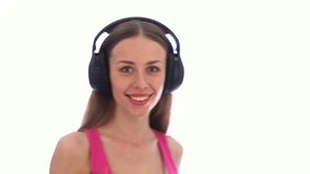 Beauty woman in headphones dancing and taking off headphones