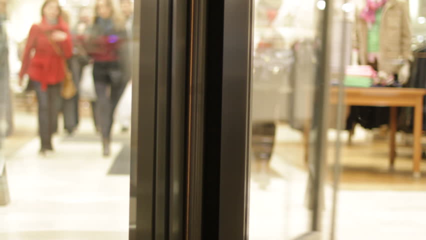 Revolving door with customers at clothes store