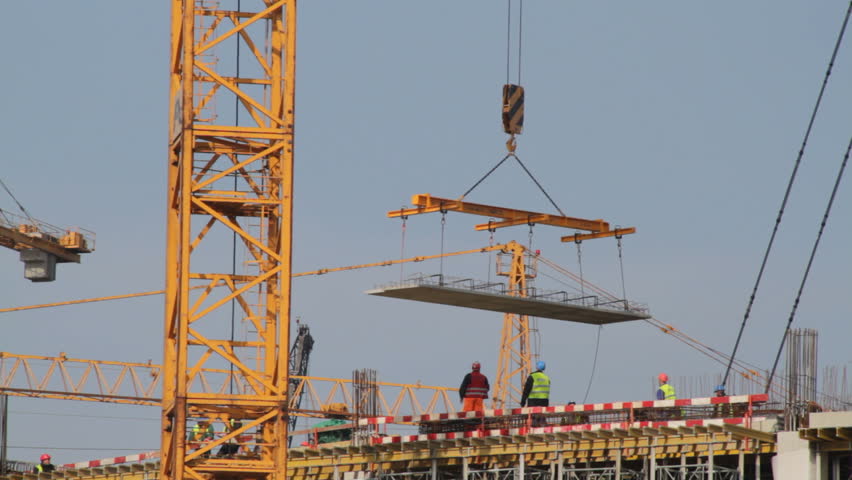Crane lowers large element at construction site